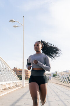 Woman running for exercise on bridge 
