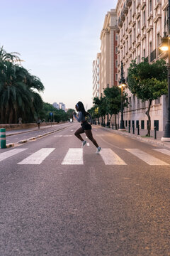Determined athlete is running in the city 