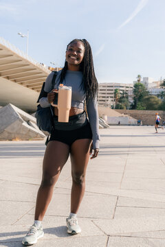 Woman posing with water bottle in the city 