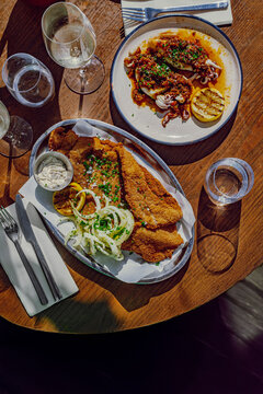 Mediterranean restaurant table with meat milanesa and grilled octopus