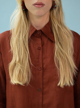 Close-up Studio Portrait of Blonde Model in Terracotta Shirt 