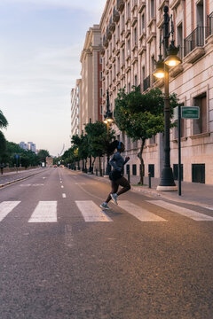 Woman running in the city during sunset 