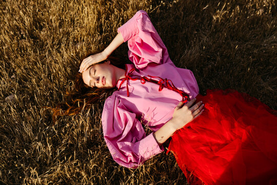 Woman relaxing lying on grass 