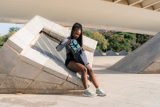 Woman taking lunch from backpack 
