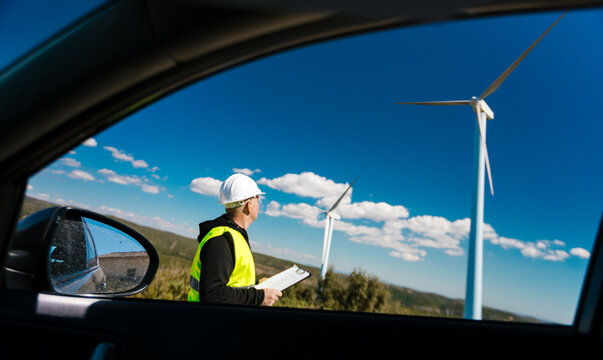 Engineer checking wind turbines generating clean energy