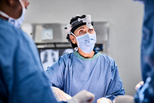 Surgeon in Scrubs Collaborates During Operation