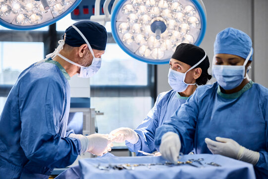 Surgeons perform operation under bright lights