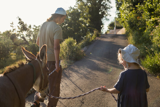 Man and child walking with donkey 