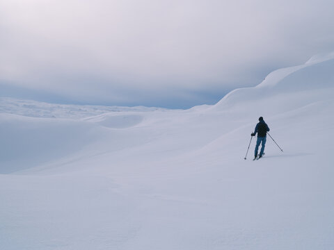 Nordic Backcountry Skier Looking Across Vast Winter Mountain Bas