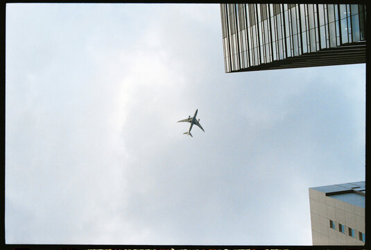 Plane Flying Over Buildings in Tokyo