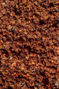 Full frame abstract macro texture of roasted dark granola.