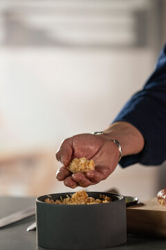Chef forming sushi rice ball for japanese cuisine