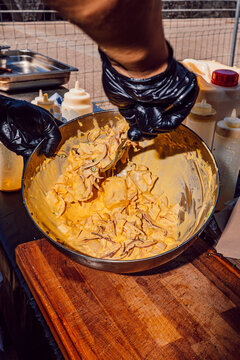 Chef mixing fresh Peruvian ceviche with aji amarillo sauce in a bowl
