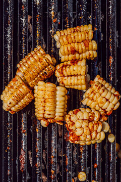 Grilled corn on the cob pieces roasting on a barbecue