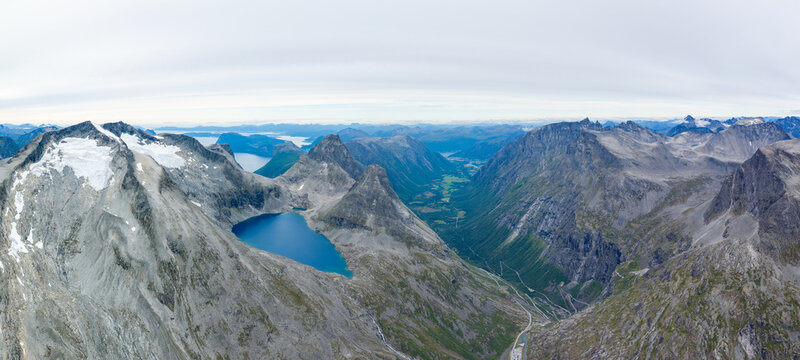 Aerial view of Bispevannet lake nestled among the dramatic peaks and rugged mountain terrain of the Trollstigen area in Andalsnes, More og Romsdal, Norway.