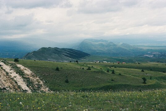 Majestic Hills Against a Cloudy Sky in Serene Landscape View