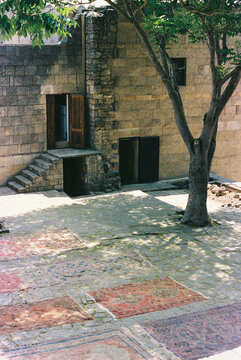 Ancient Courtyard Filled With Vibrant Rugs and Peaceful Trees
