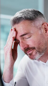 Businessman, headache and glasses in office with computer, paralegal mistake and lawsuit pressure. Lawyer, mature person and migraine in firm with desktop, legal error and tired of court case stress.
