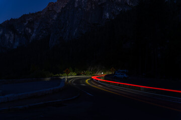 Car light trails on a winding mountain road at night in Yosemite National Park, California, USA © Qiang