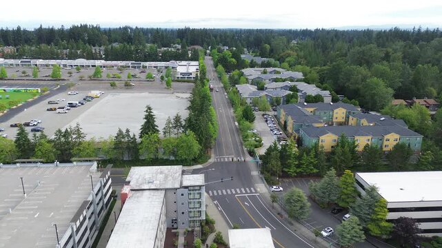 Paved asphalt lanes stretch past Pete von Reichbauer Way South, dividing commercial parking lots from residential developments, emphasizing systematic municipal zoning in Federal Way, WA