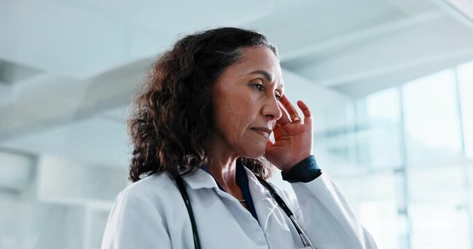 Doctor, woman and headache in hospital with stress, thinking and difficult decision for patient care. Healthcare worker, mature person and migraine in medical clinic with fatigue, burnout and crisis.
