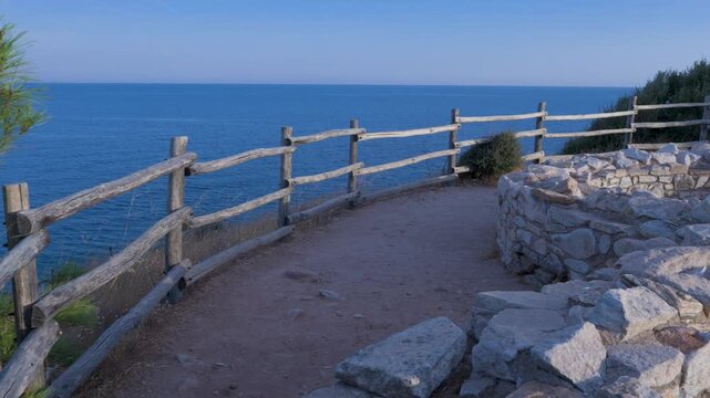 walking POV, travel, gimbal shot, greece, thassos, aliki, sea, path, stone wall, coastal, trail, mediterranean, aegean sea, island, summer, vacation, walking, exploration, nature, outdoor, pine trees,