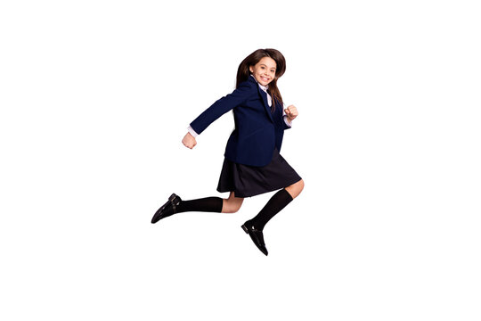 Full length body size view of her she attractive active cheerful cheery small little long-haired girl jumping running lesson first grade isolated lilac violet pastel color background