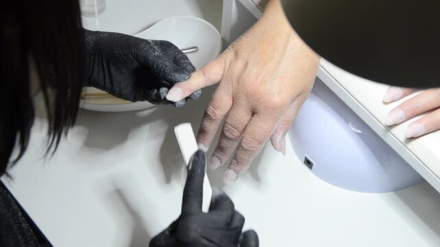 Manicurist Shaping Fingernails with Nail File Close Up