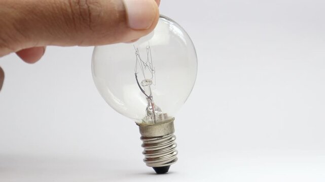 Incandescent bulb used in fancy lighting with visible tungsten filament inside and a screw base on a white background