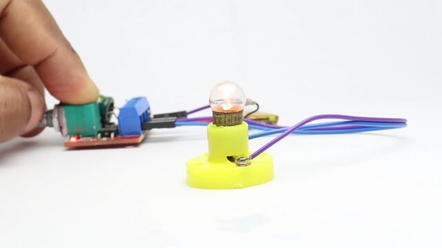 Incandescent torch bulb being tested for functionality connected to a controller with a lipo battery in the background