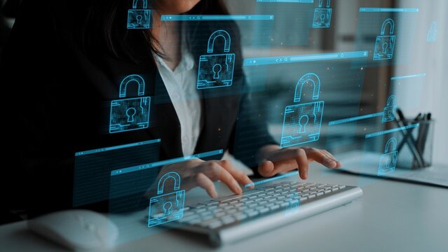 Futuristic Digital Security Concept with Cyber Lock Symbols Displayed on Screen and Person Typing on Computer Keyboard in Modern Office Environment. Entropy.