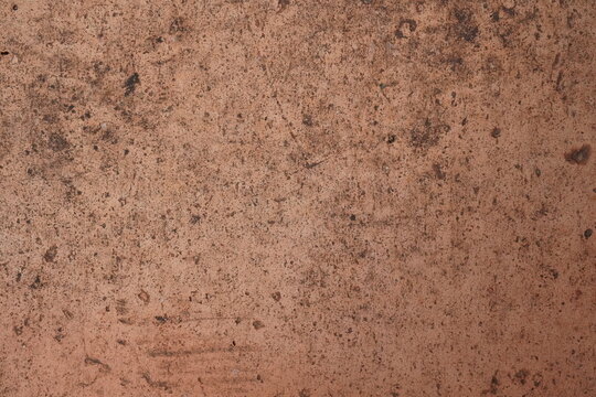 Rustic red clay ground surface texture, earthy tones, architectural material.