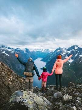 Family coolcation in Norway -  parents travel with child hiking together active vacations outdoor, father, mother and daughter climbing mountains healthy lifestyle explore Romsdal offbeat trails