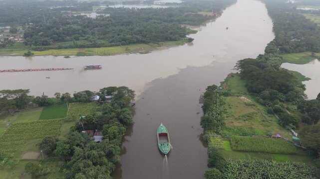 High aerial drone view of two river streams joining together in village