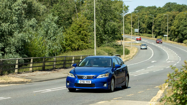 Milton Keynes,UK - July 25th 2026: 2011 blue Lexus ct hybrid electric car driving on a British road