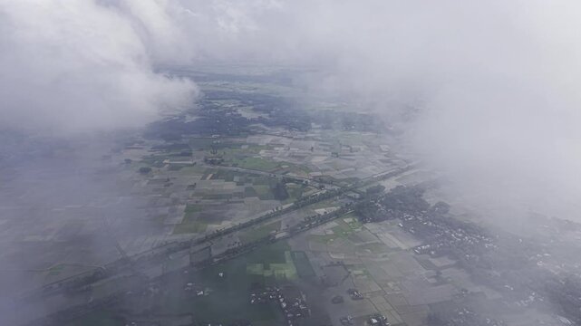 Aerial footage captured from approximately 500 meters above the ground, showing a stable drone viewpoint while clouds slowly drift from one side of the frame to the other, creating natural movement.