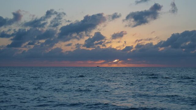 Sunrise seascape. Romantic summer vacation seascape. Sea sunset horizon. Sunset cloudy sky. Seascape at summer vacation. Skyscape with sea horizon. Horizon sunrise sea with ship. 4k footage