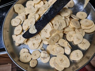Raw banana slices prepared for making homemade crispy banana chips © amith