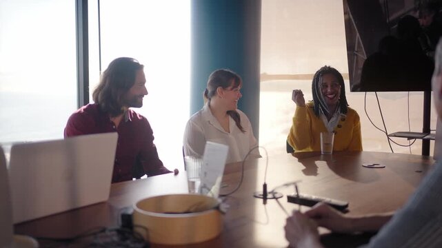Professionals gather around a table in a contemporary office setting, actively participating in a productive meeting, fostering teamwork and innovation
