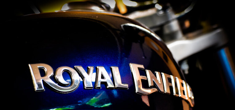 KERALA, INDIA - JULY 20, 2020: Close up of chrome Royal Enfield logo emblem on blue metallic fuel tank with selective focus.