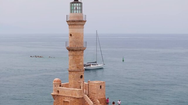  View of Chania with the amazing lighthouse, mosque, venetian shipyards, Crete, Greece.Waves crashing on lighthouse, Beautiful Greece and best scenic places - panorama