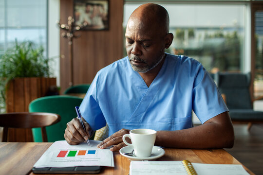 Healthcare professional reviewing reports at cafe table