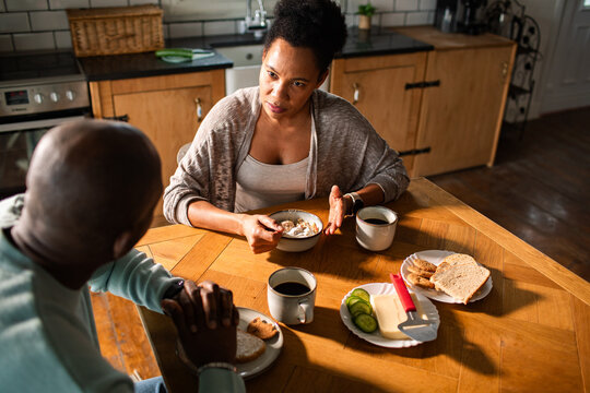 Couple having a serious breakfast conversation at home