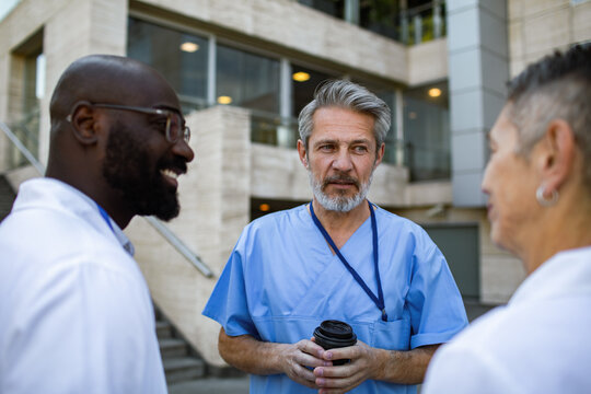 Doctors and nurses talking outside hospital
