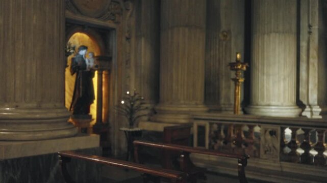 Blurred church interior with soft bokeh and defocused marble columns, carved balustrade and wooden pews; background backplate copyspace calm.