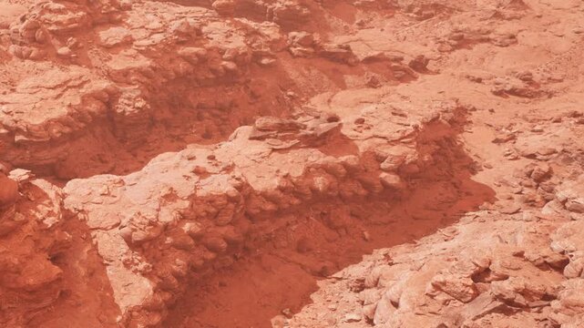 The scene shows a rocky surface on Mars with various formations and textures. The reddish color dominates the landscape, highlighting the intricate shapes and contours of the terrain.