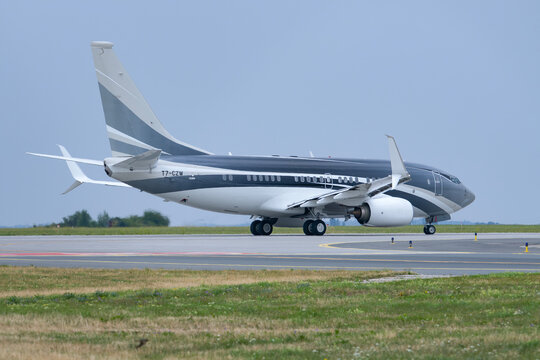 PRAGUE, CZECH REPUBLIC &ndash; AUGUST 1, 2026: Titan Aviation Boeing 737-7JW BBJ T7-CZW taxiing at V&aacute;clav Havel Airport Prague.