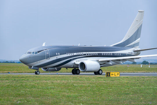 PRAGUE, CZECH REPUBLIC &ndash; AUGUST 1, 2026: Titan Aviation Boeing 737-7JW BBJ T7-CZW taxiing at V&aacute;clav Havel Airport Prague.