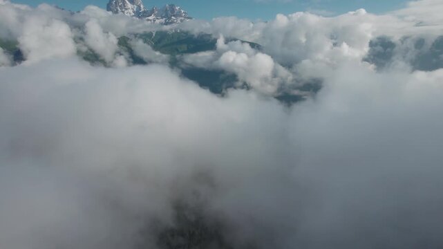 Drone rises above the clouds revealing the majestic summit of Mount Ushba in Svaneti, Georgia. Cinematic aerial footage of the Caucasus Mountains, perfect for travel, meditation and nature projects