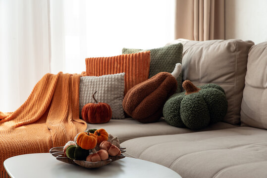 Cozy Autumn Living Room Arrangement With Decorative Pumpkins and Throws Creating Warm Seasonal Ambiance